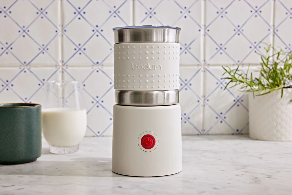 Bodum Bistro electric milk frother with warm milk foam in a small kitchen