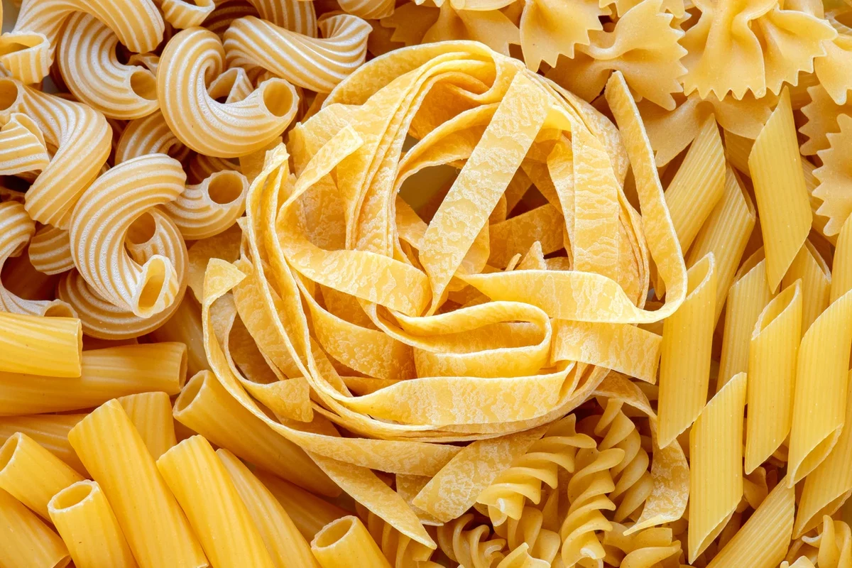 Bronze cut pasta with tomato sauce in a home kitchen bowl
