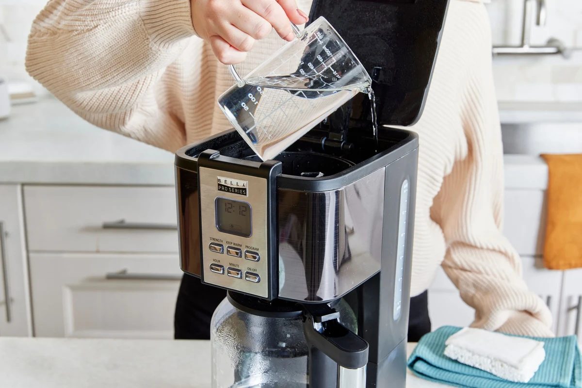 French press coffee maker with freshly brewed coffee on a kitchen counter
