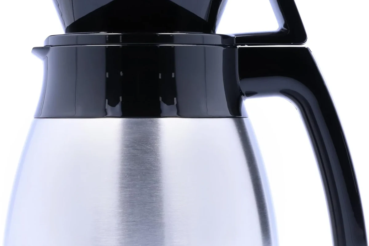 French press coffee in a glass press with rich dark brew on a kitchen counter