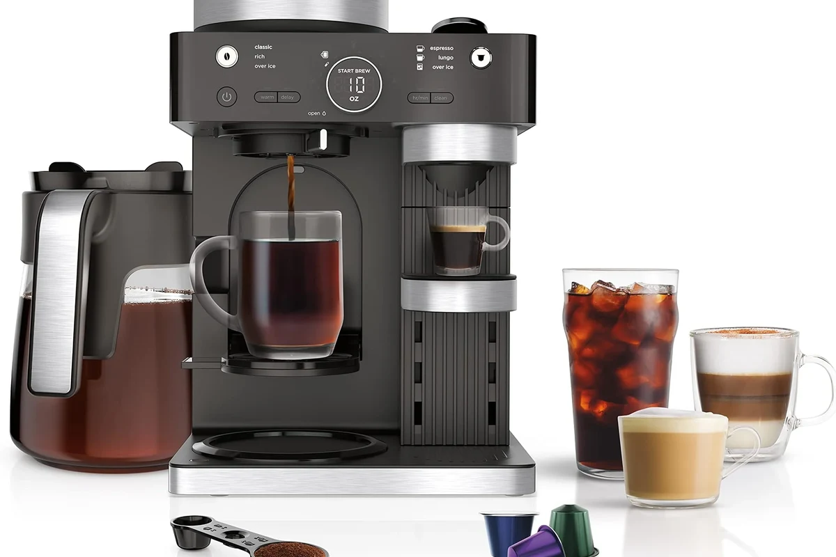 French press coffee maker with grounds, hot water, and a brewing setup in a home kitchen