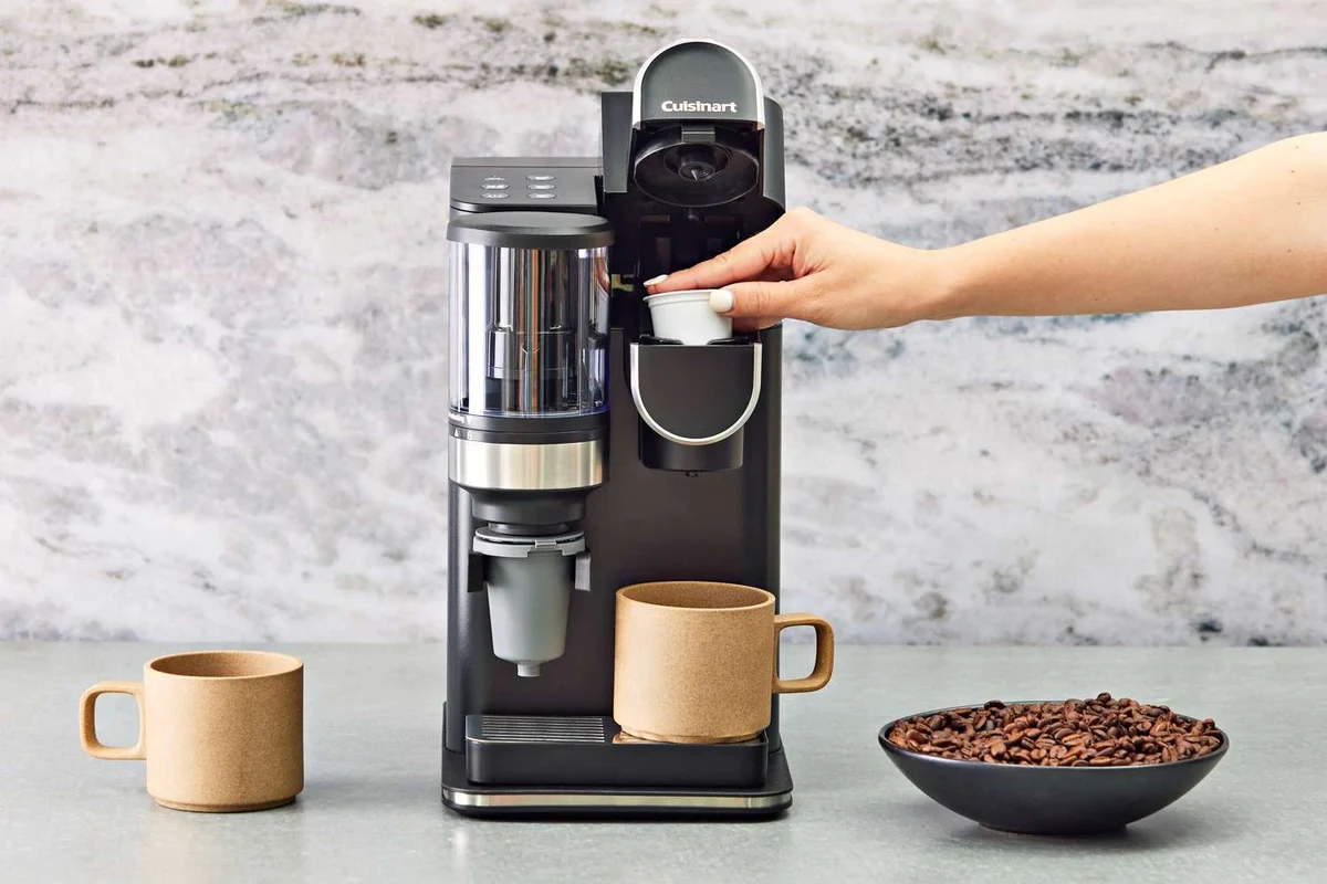 Bodum French press coffee maker with coarse grounds, hot water, and a brewing setup on a kitchen counter