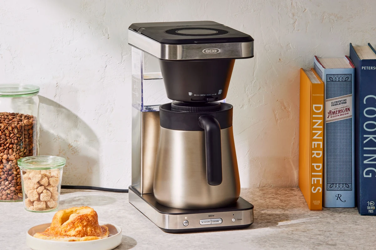 French press coffee maker with glass carafe, plunger, and brewed coffee on a kitchen counter