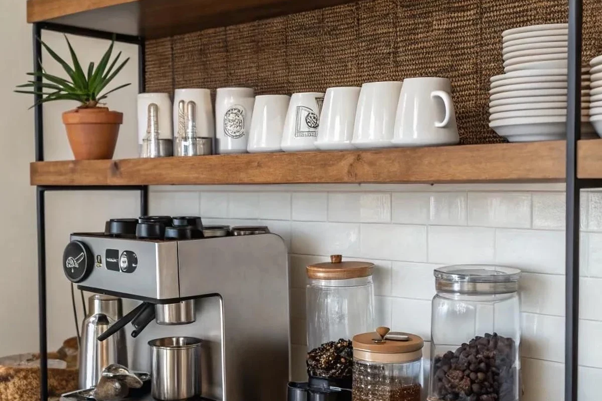 French press coffee maker with coarse grounds, hot water, and a brewing setup on a kitchen counter