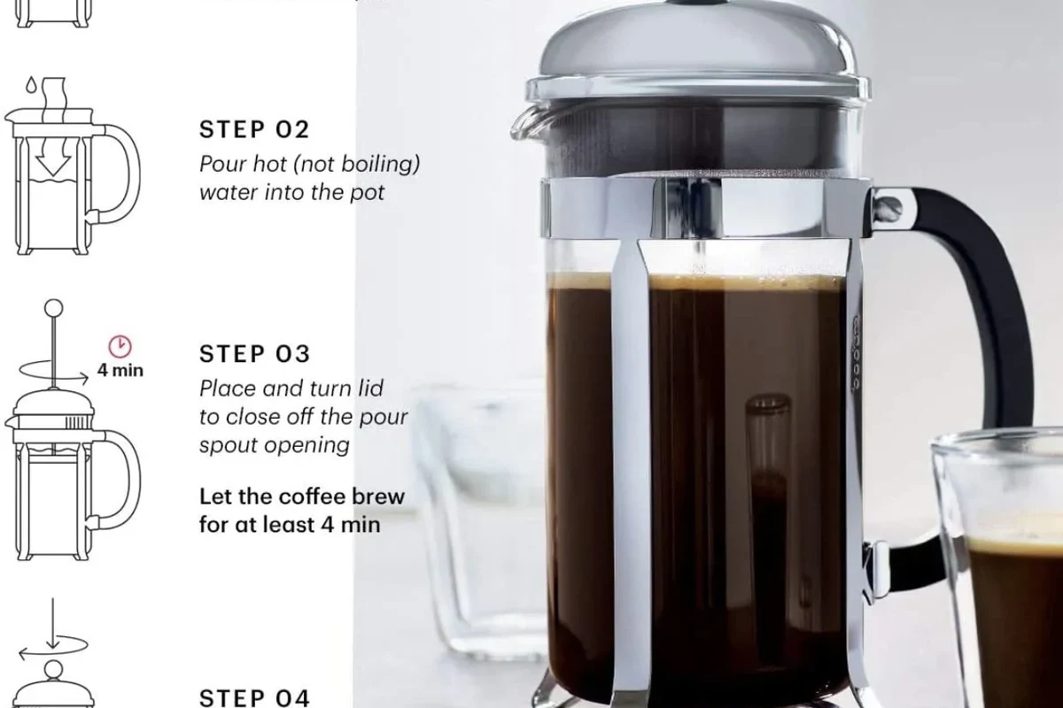 French press coffee maker with coarse grounds, hot water, and a finished cup on a kitchen counter