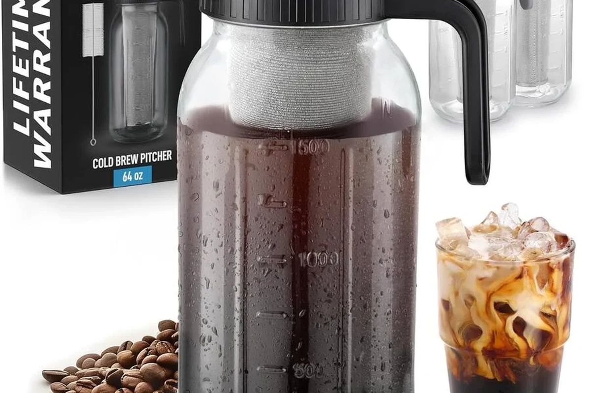 French press coffee brewer with coarse grounds, hot water, and a cup on a kitchen counter