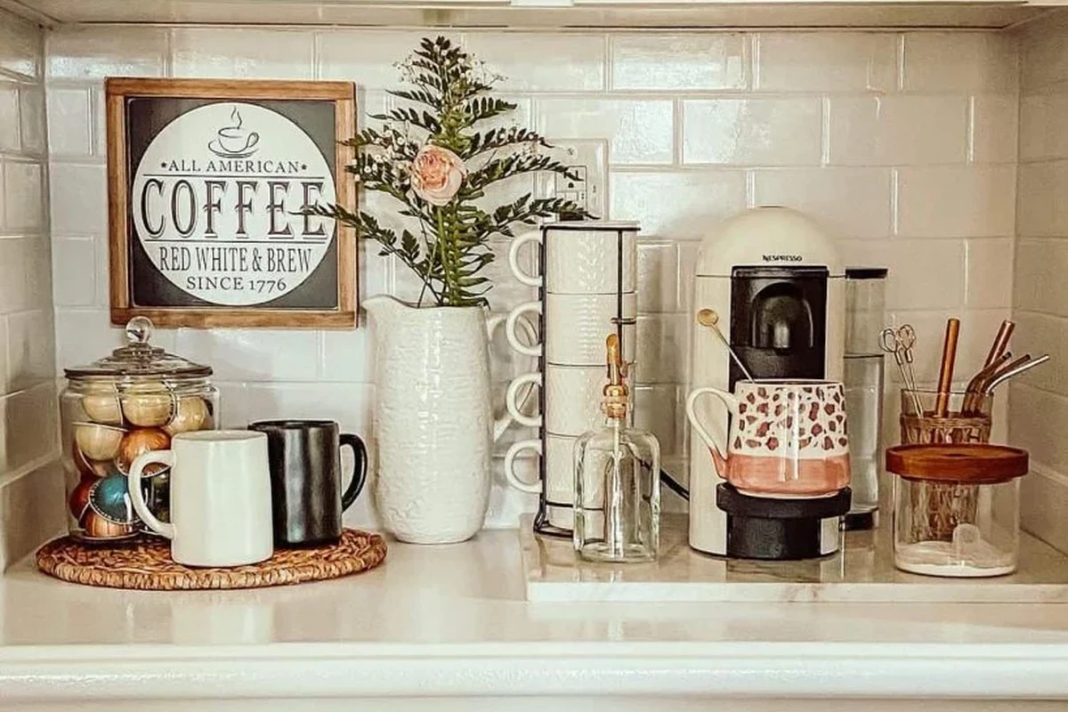 French press coffee maker with plunger, coffee grounds, and hot water on a kitchen counter