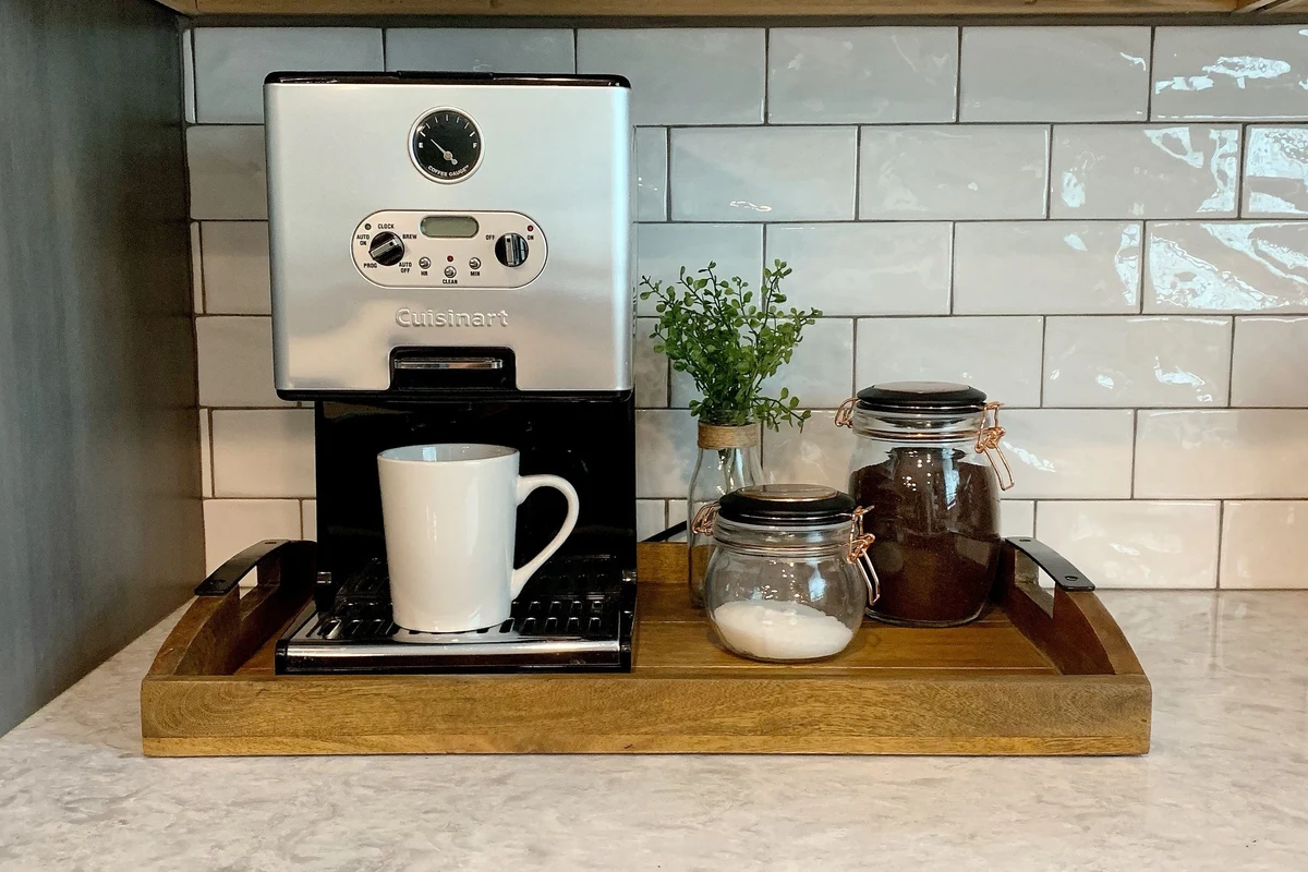 French press coffee maker with glass carafe, plunger, and brewed coffee on a kitchen counter