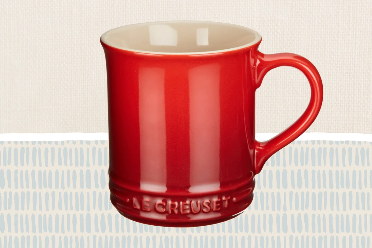 Coffee mugs on a kitchen counter with a warm morning coffee setup