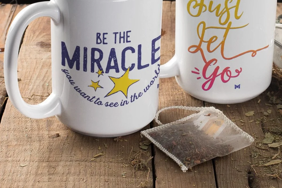Cozy coffee mug on a kitchen table beside a warm drink and soft morning light