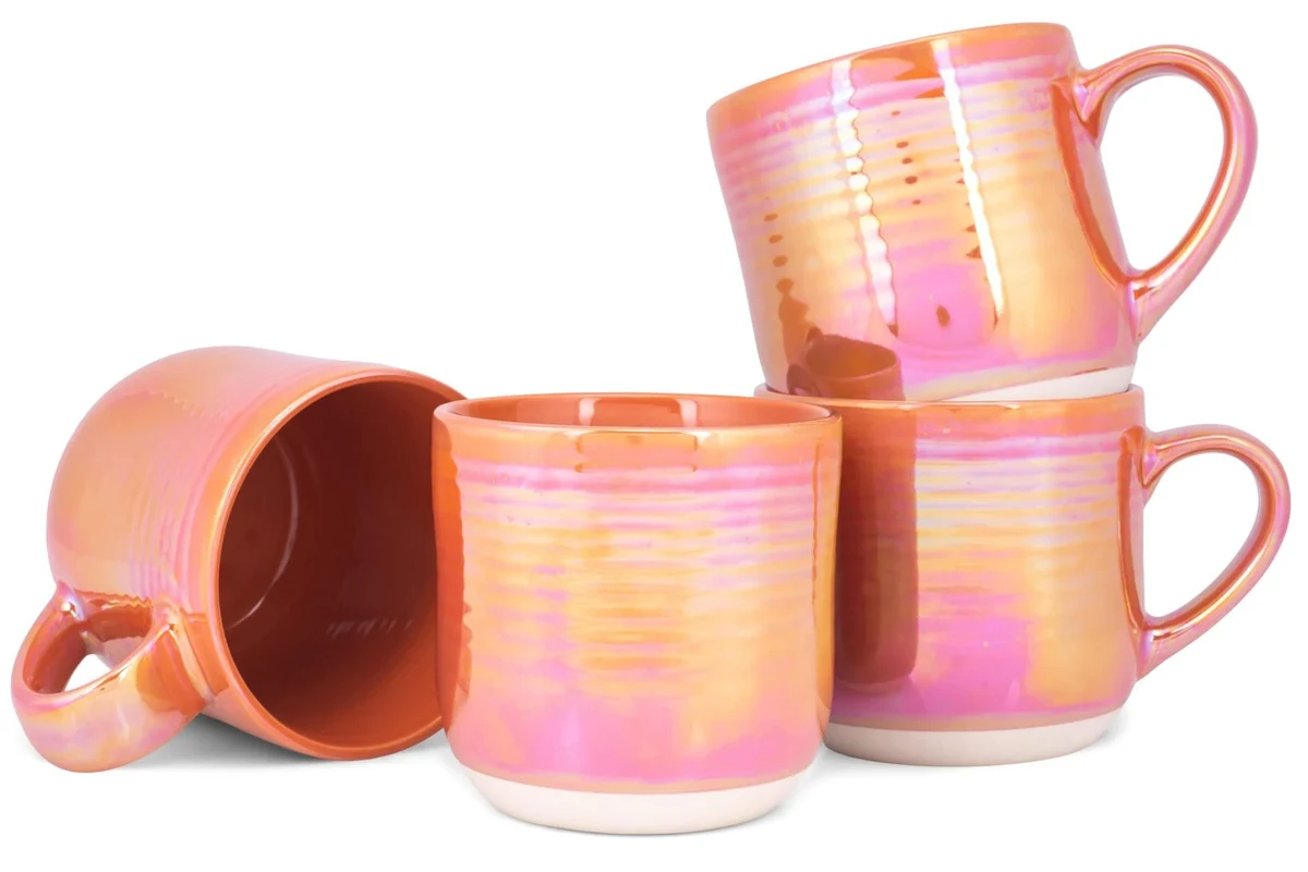 Cozy coffee mug on a kitchen table beside a warm drink and soft morning light