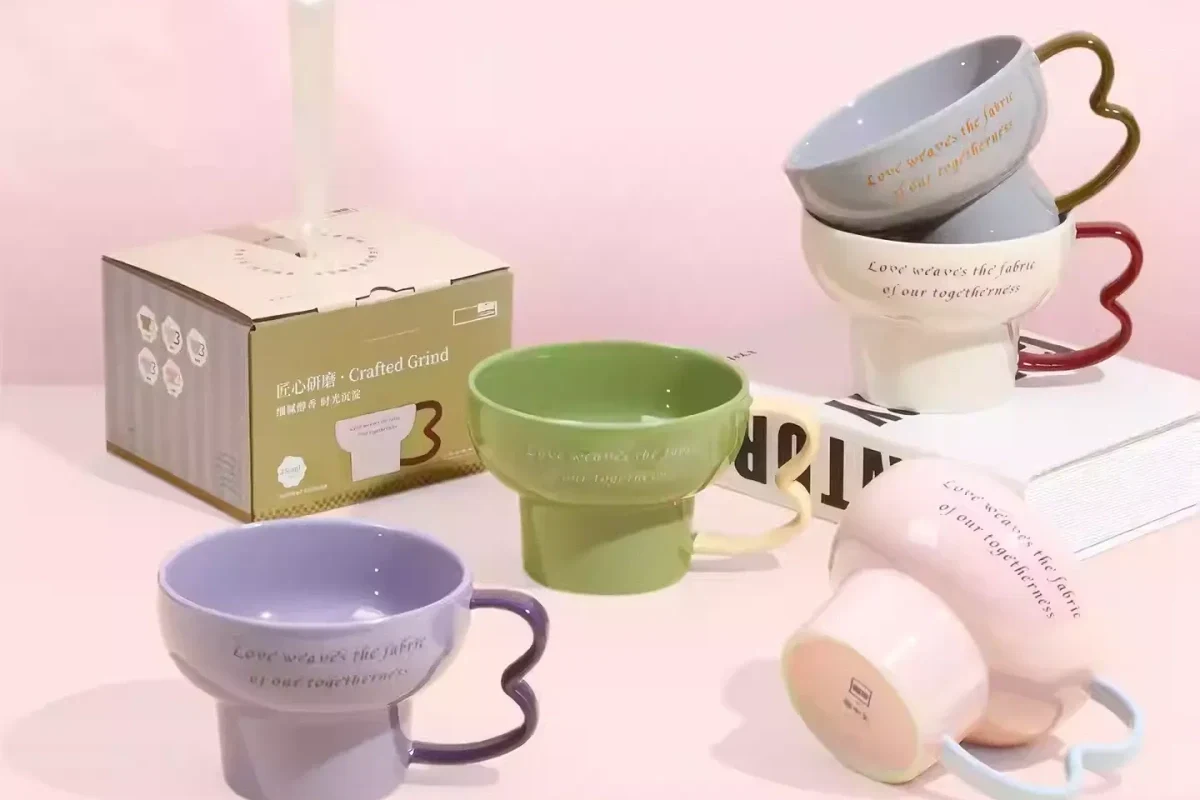 Ceramic coffee mugs on a kitchen counter with one chipped mug for safety context