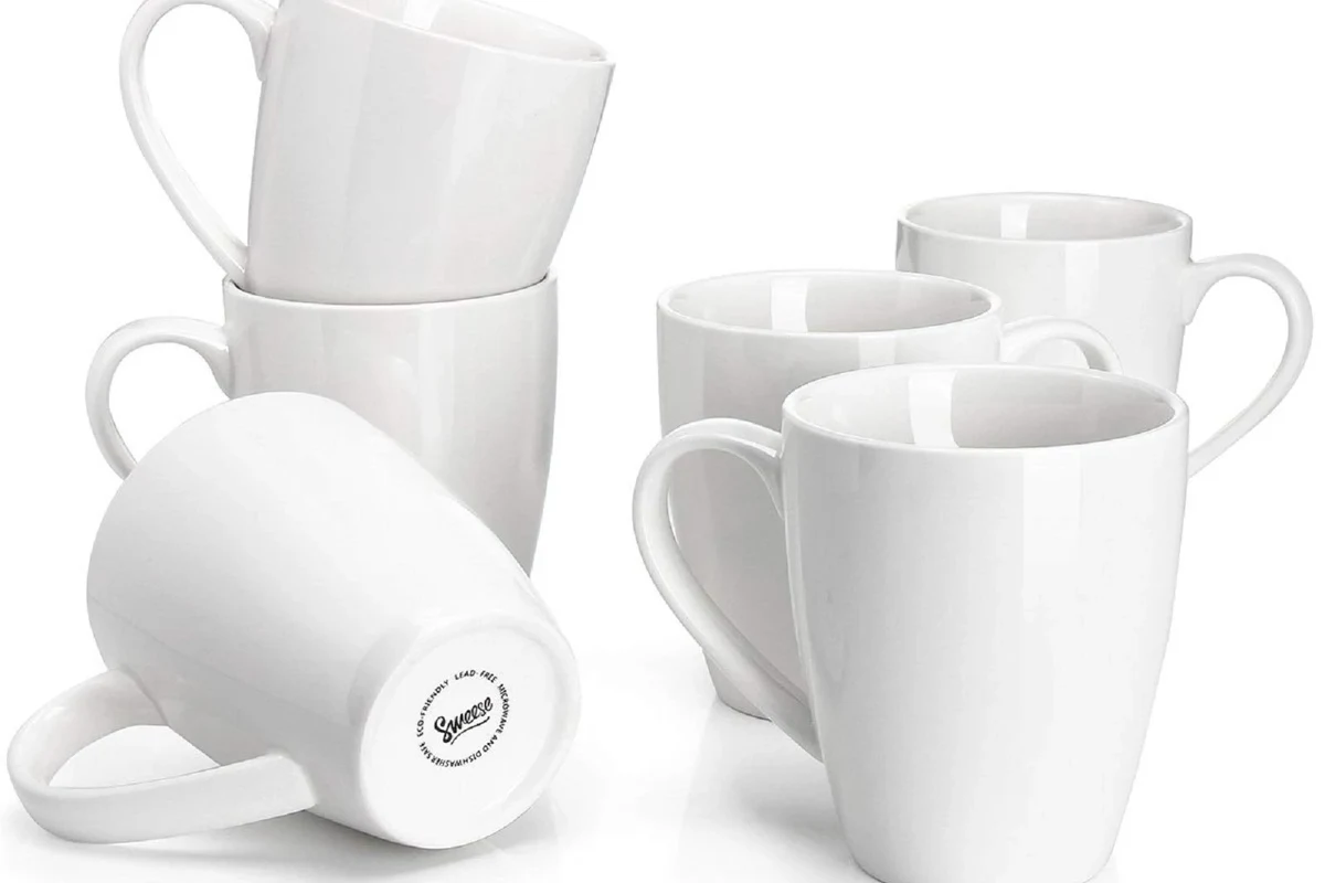 Lead-free coffee mugs in glass, ceramic, porcelain, and stainless steel on a clean kitchen counter