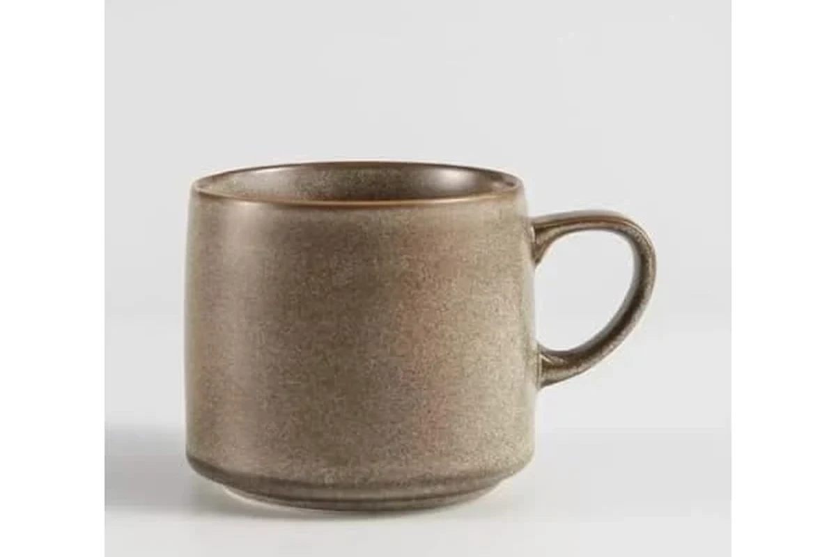 Lead-free coffee mugs in glass, ceramic, porcelain, and stainless steel on a clean kitchen counter