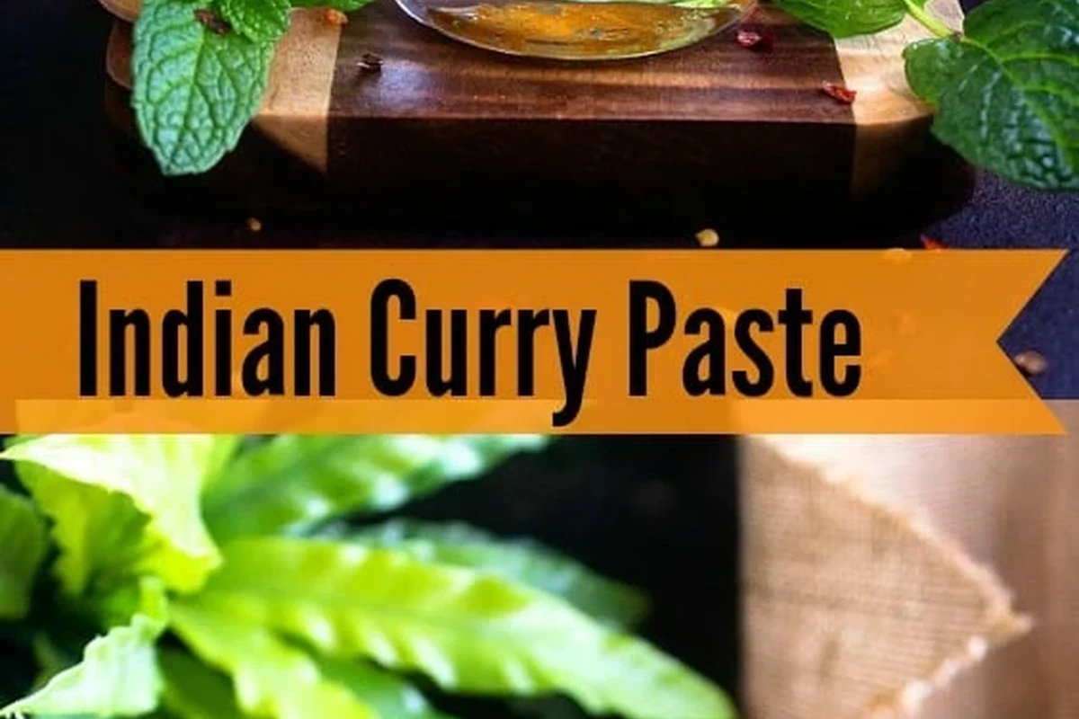 Bowl of curry paste cooking with oil, vegetables, rice, and pasta ingredients in a home kitchen