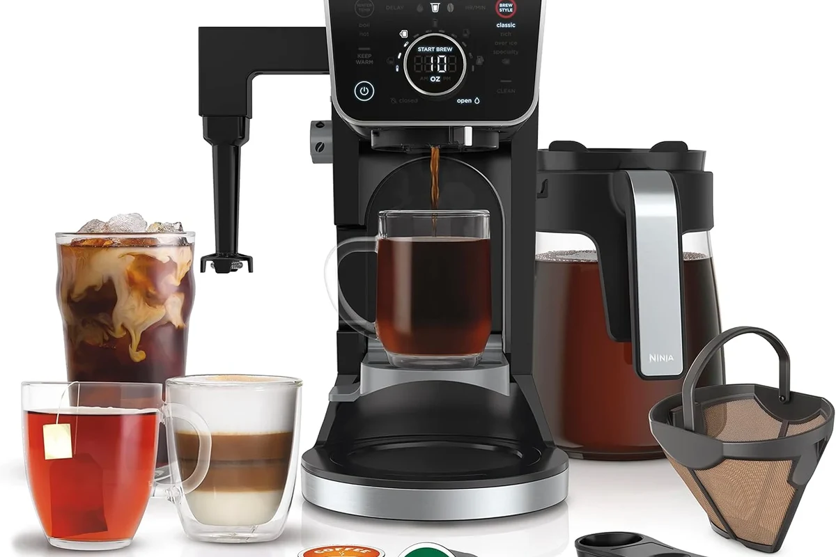 French press coffee maker with brewed coffee, grounds, and simple kitchen setup