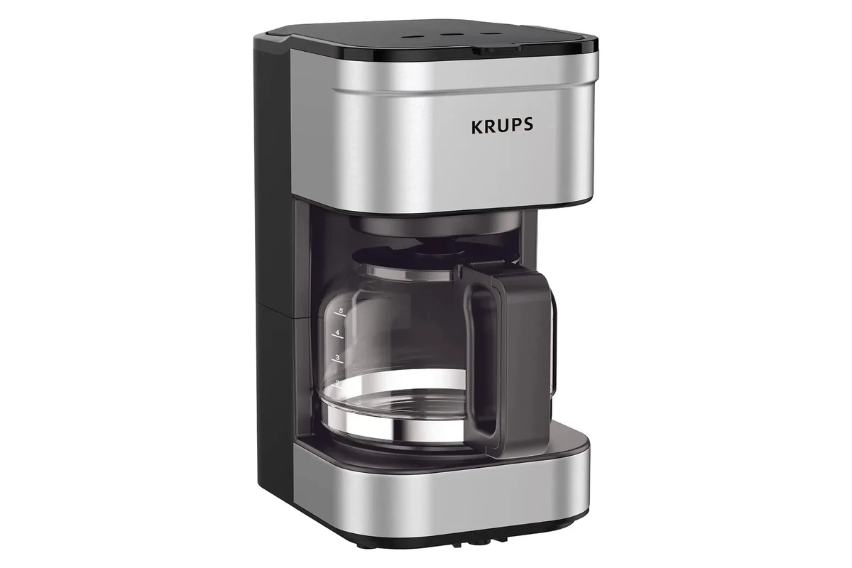 French press coffee maker being cleaned with warm water, soap, and a soft brush in a kitchen sink