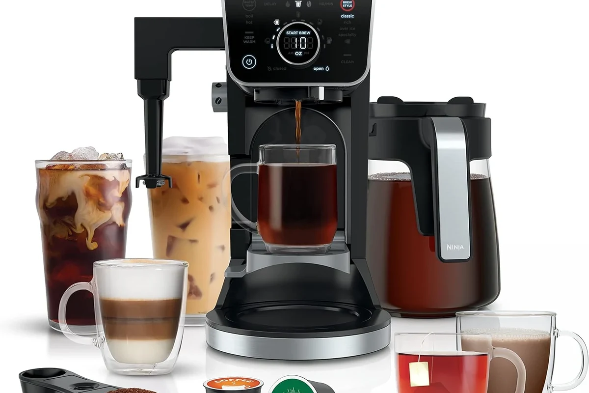 Bodum French press coffee maker with coarse grounds, hot water, and a brewing setup on a kitchen counter
