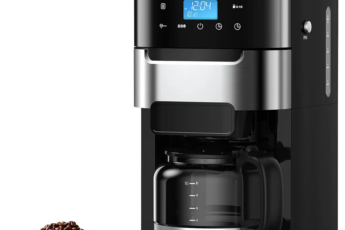 French press coffee maker with coffee grounds, hot water, and brewing setup on a kitchen counter