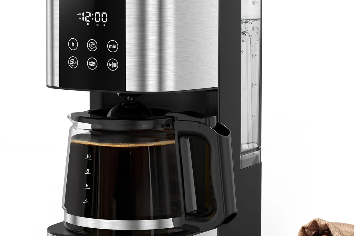French press coffee maker with grounds, kettle, and measuring tools on a kitchen counter