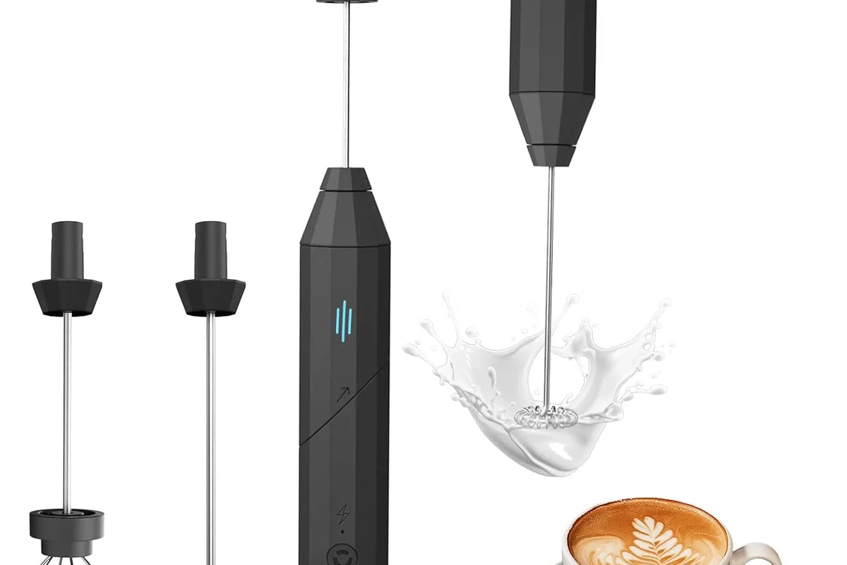Electric milk frother making hot foam for coffee on a kitchen counter