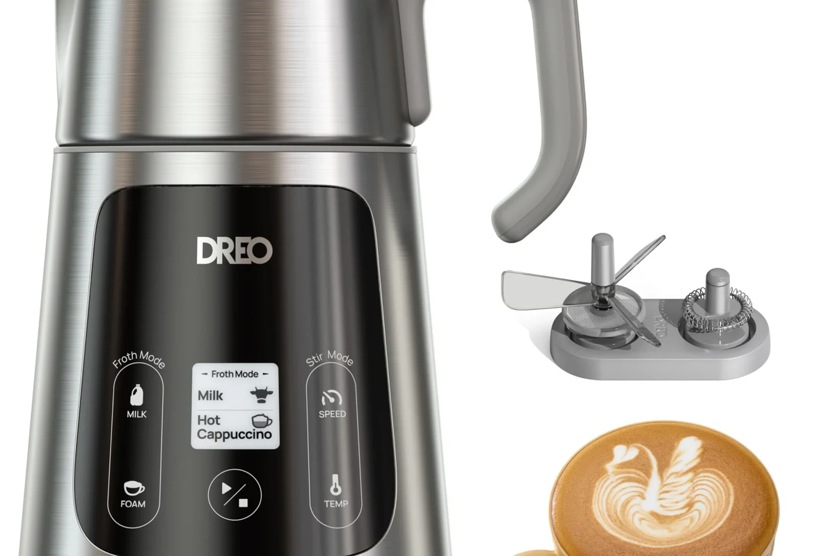 Electric milk frother on a kitchen counter with steamed milk and safe use setup