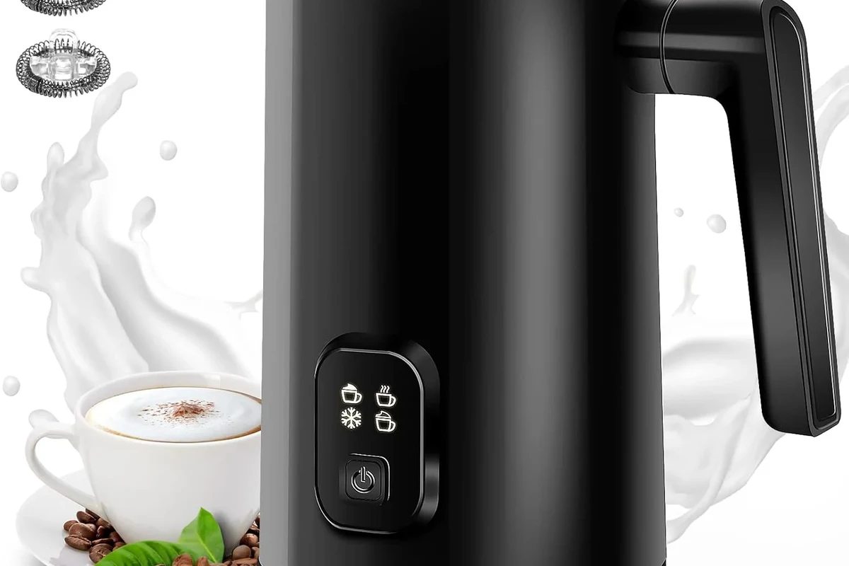 Electric milk frother whisking milk into foam in a home kitchen mug