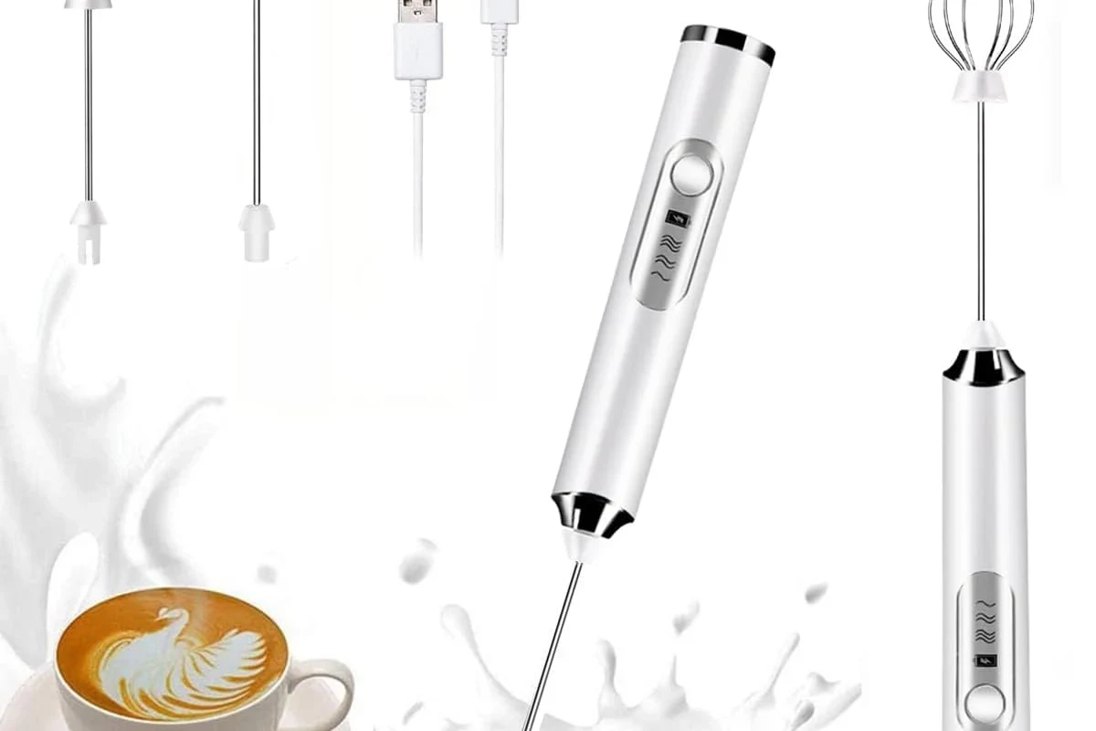 Electric milk frother whisking milk into foam in a home kitchen