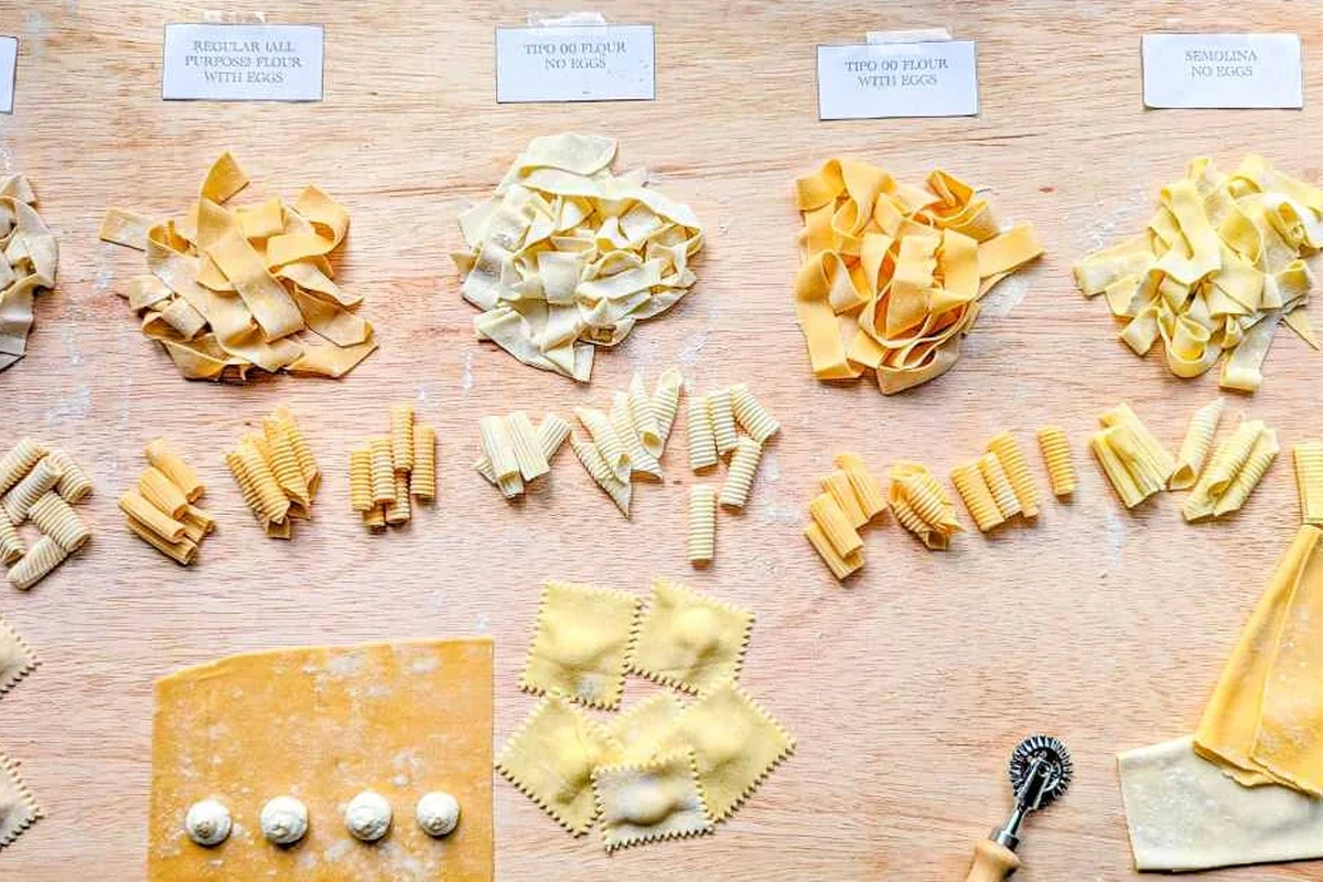 Fresh pasta dough with flour types including semolina, 00 flour, and all-purpose flour on a kitchen counter