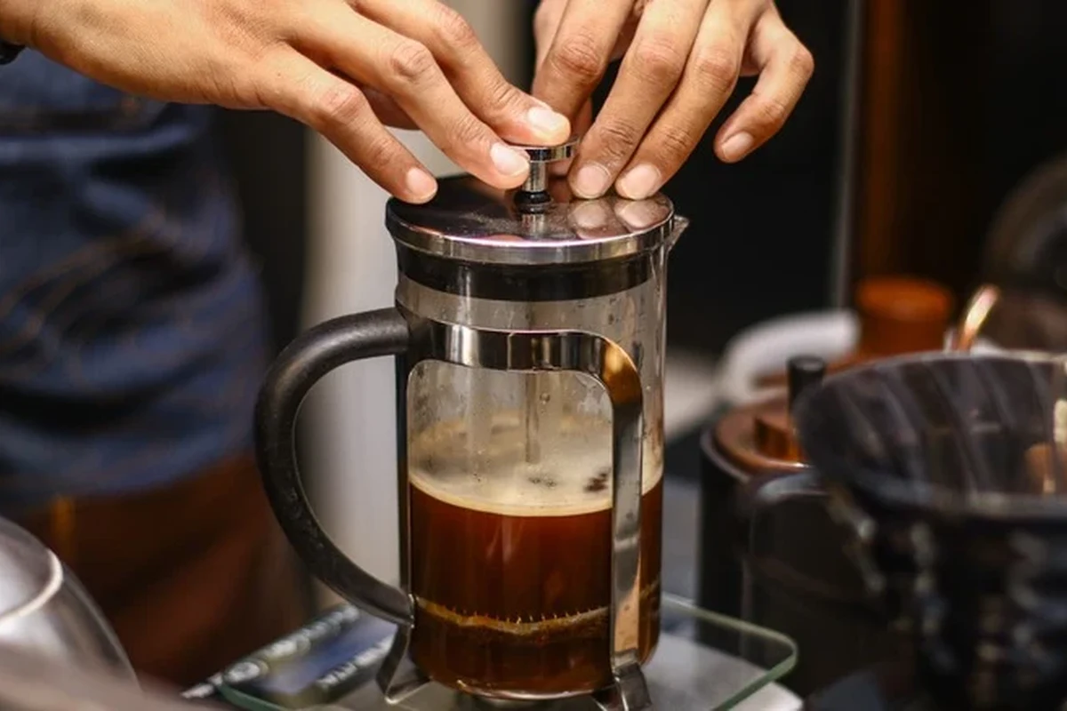 French press coffee maker with rich brewed coffee on a kitchen counter