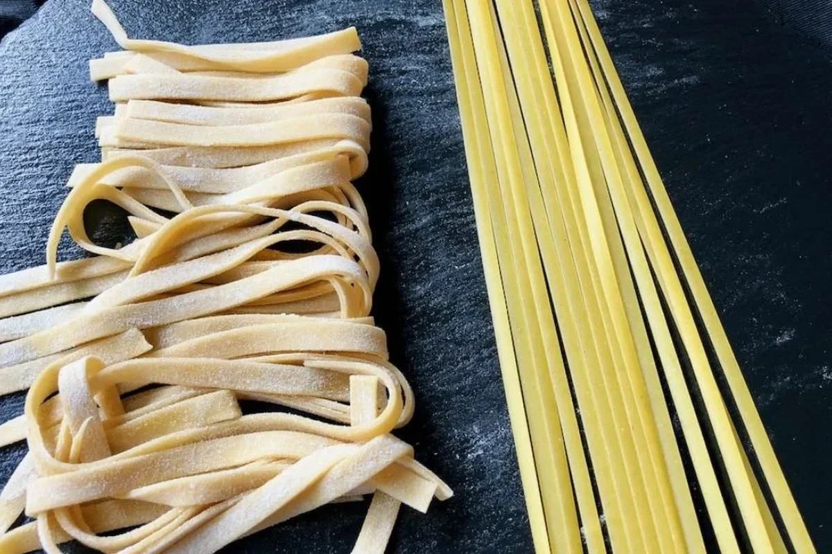 Fresh pasta and dried pasta served with simple sauces in a home kitchen