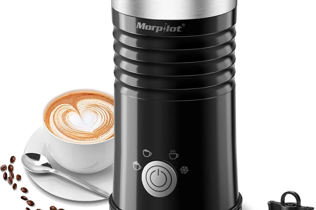 Electric milk frother making smooth milk foam in a home kitchen mug