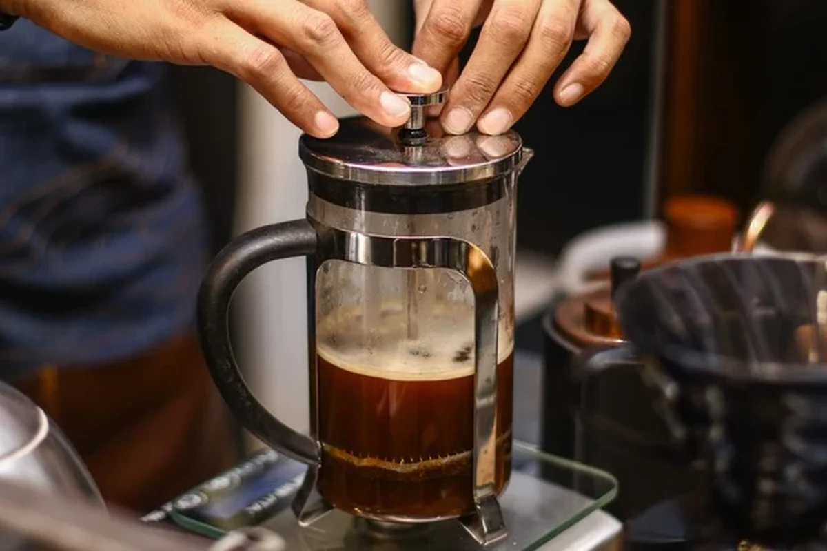 French press coffee brewing checklist with grounds, kettle, and cup on a kitchen counter