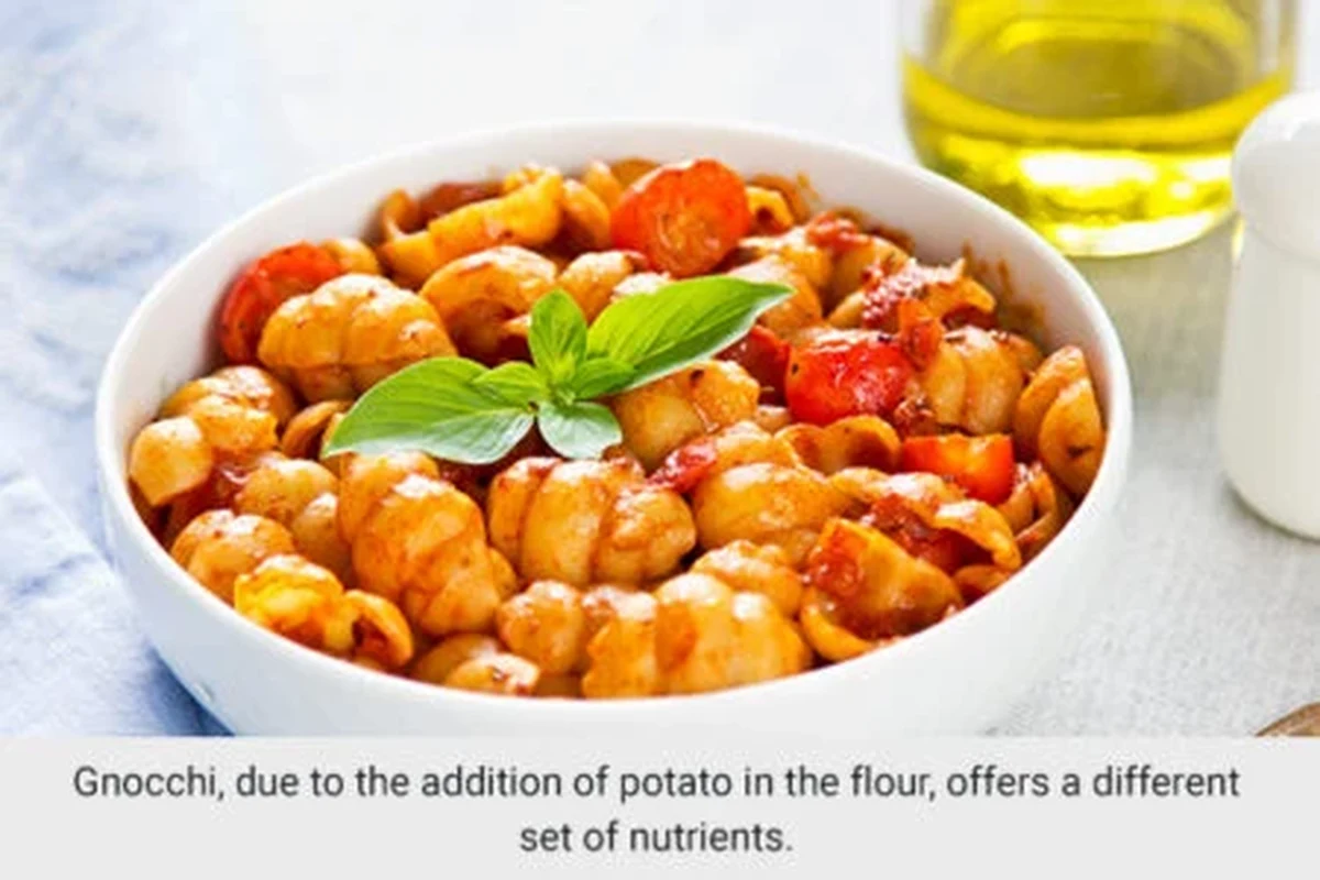 Bowl of gnocchi and pasta with tomato sauce, vegetables, and simple kitchen styling