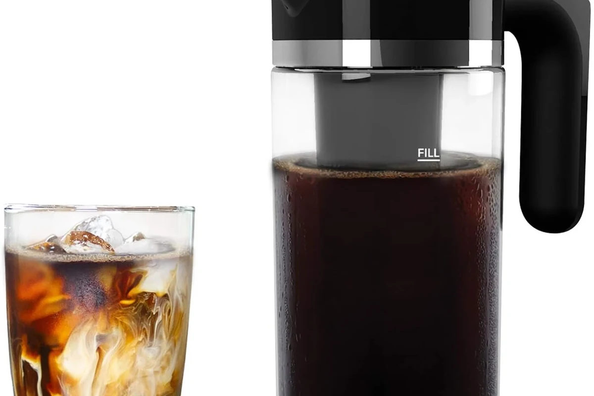 Cold brew coffee maker with glass pitcher, fine filter, and coffee grounds in a kitchen fridge