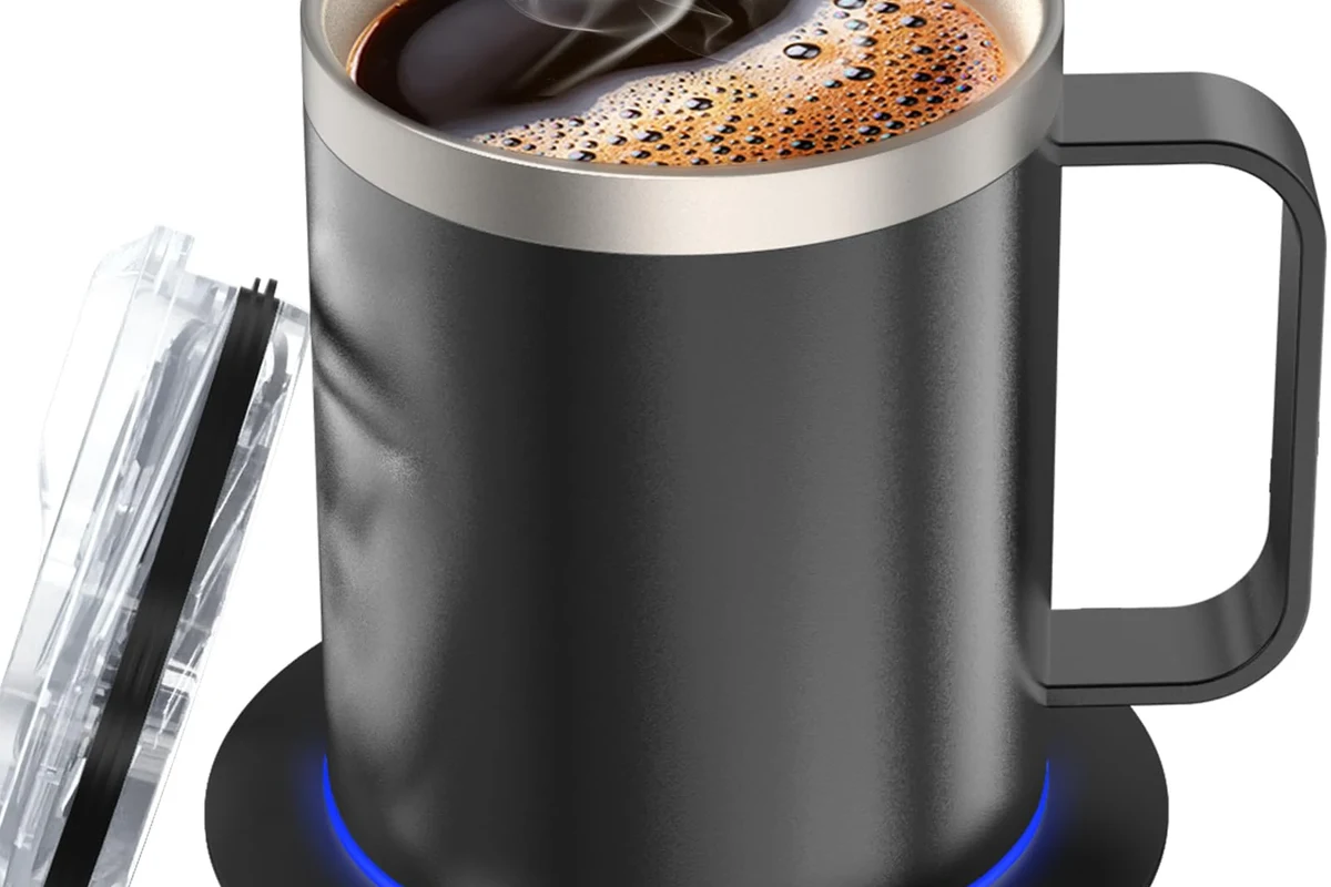 Heated coffee mug on a kitchen counter beside a corded warming base