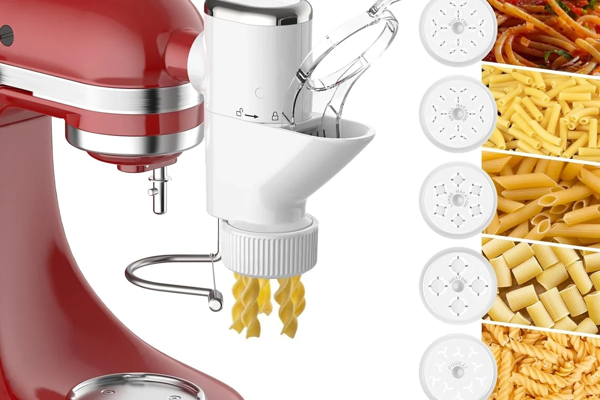KitchenAid stand mixer with pasta attachment rolling fresh dough on a clean kitchen counter