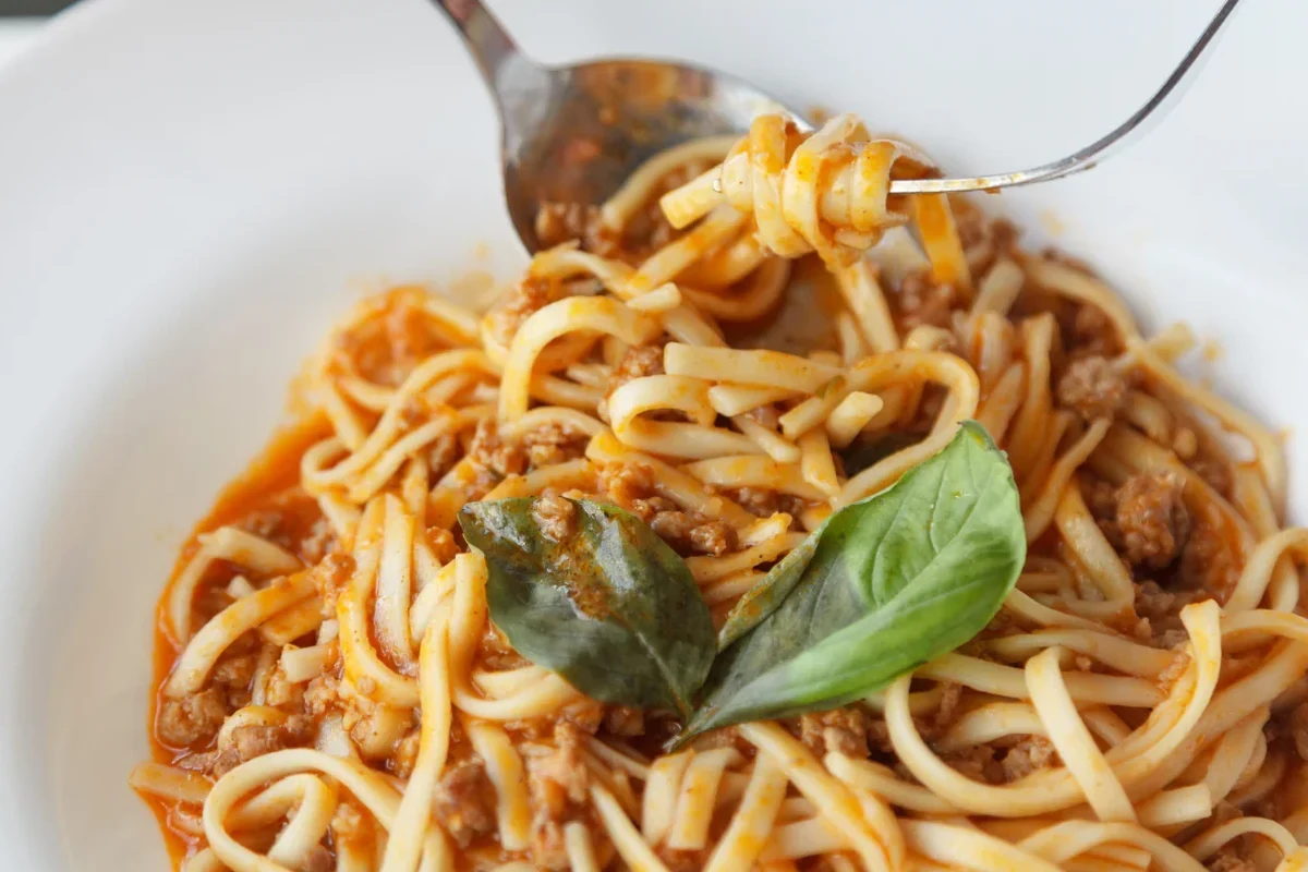 Dry pasta stored in airtight containers on a clean pantry shelf