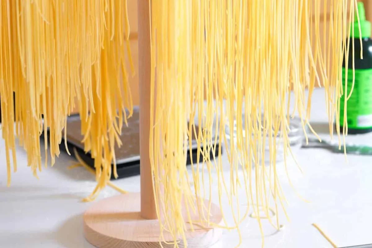 Homemade dried pasta stored in an airtight jar on a kitchen shelf