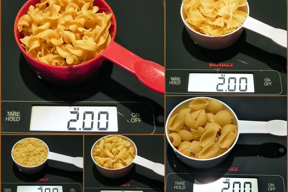 Dry pasta in a measuring cup beside a kitchen scale on a clean counter
