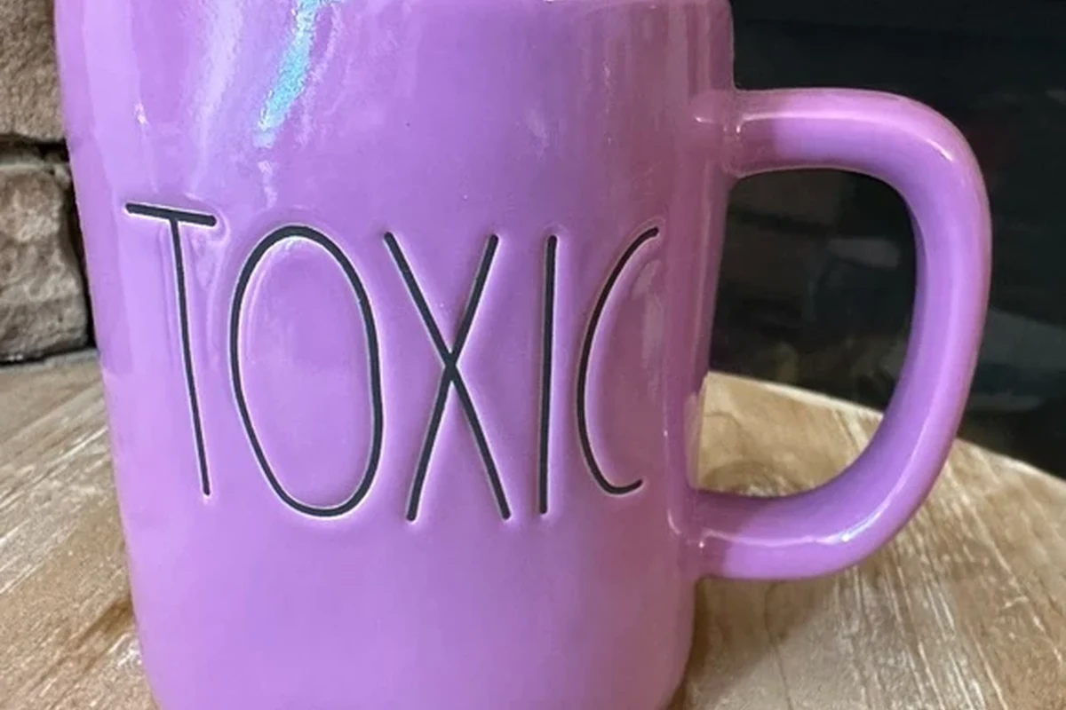 Assorted coffee mugs made of ceramic, glass, steel, and plastic on a kitchen counter