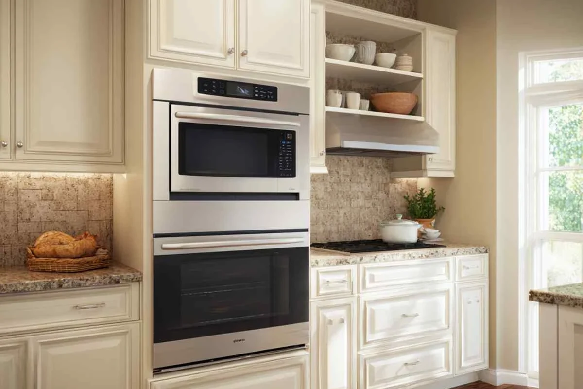 Coffee mug being checked for microwave safety beside a microwave in a bright kitchen