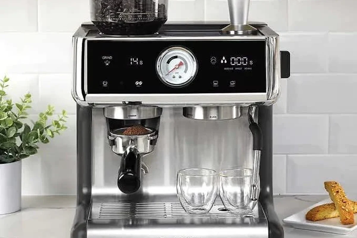 Electric milk frother making creamy foam for a home coffee drink