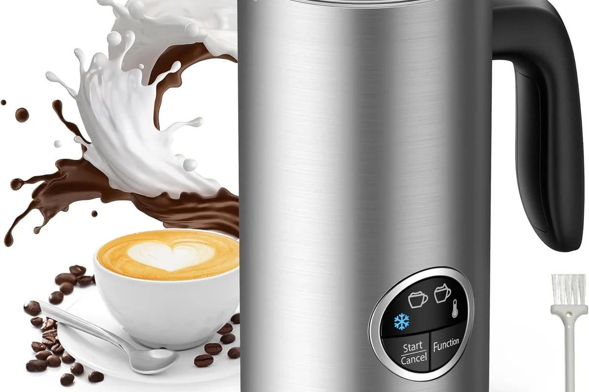 Milk frother making foam in a home kitchen beside coffee cups