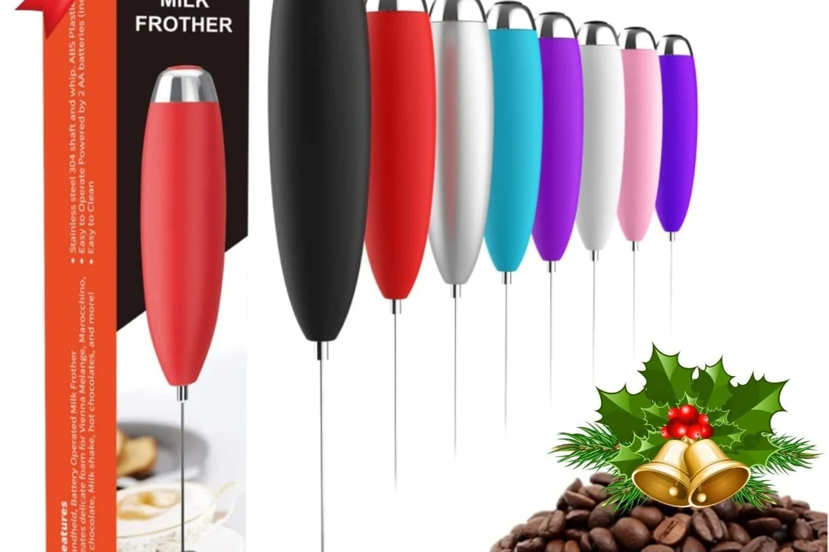 Milk frother beside a cup of coffee with smooth foam in a home kitchen