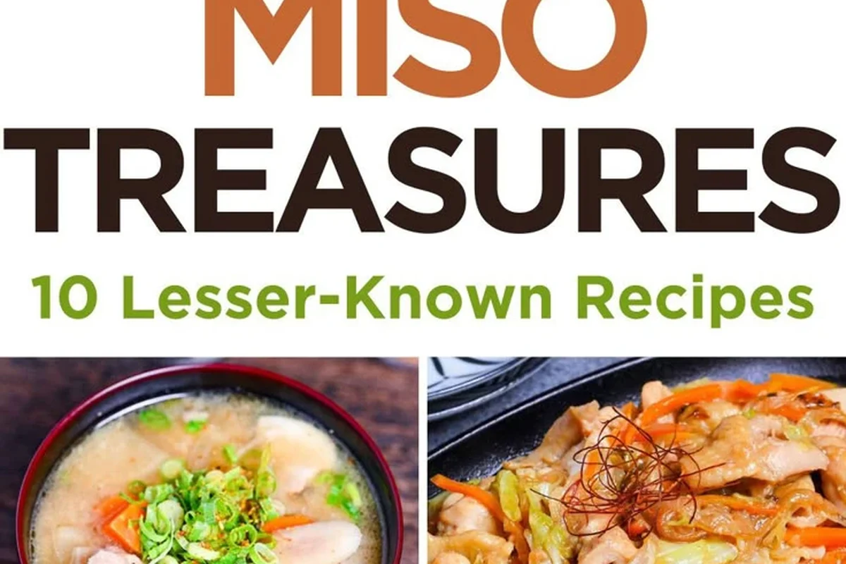 Bowl of miso paste with soybeans, rice, salt, and wooden spoon on a kitchen counter