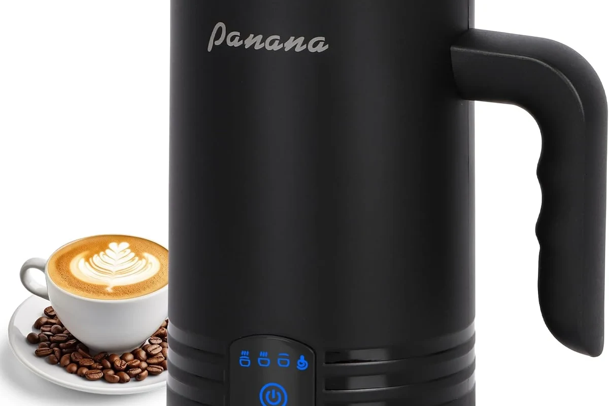 Electric milk frother with removable lid and whisk on a clean kitchen counter