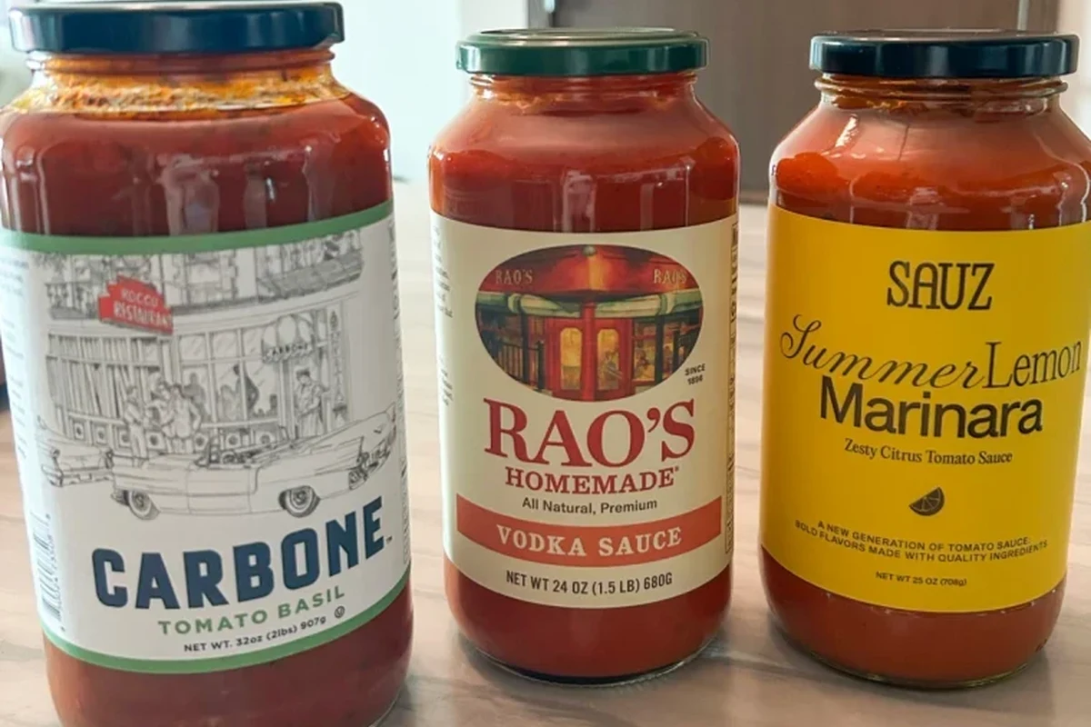 Bowl of plain pasta with mild sauce ingredients on a kitchen counter