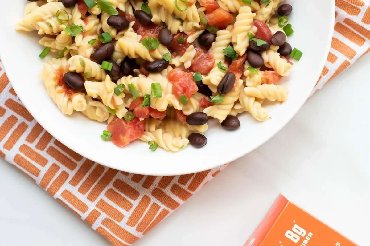 Bowl of pasta with vegetables and whole wheat noodles on a kitchen table