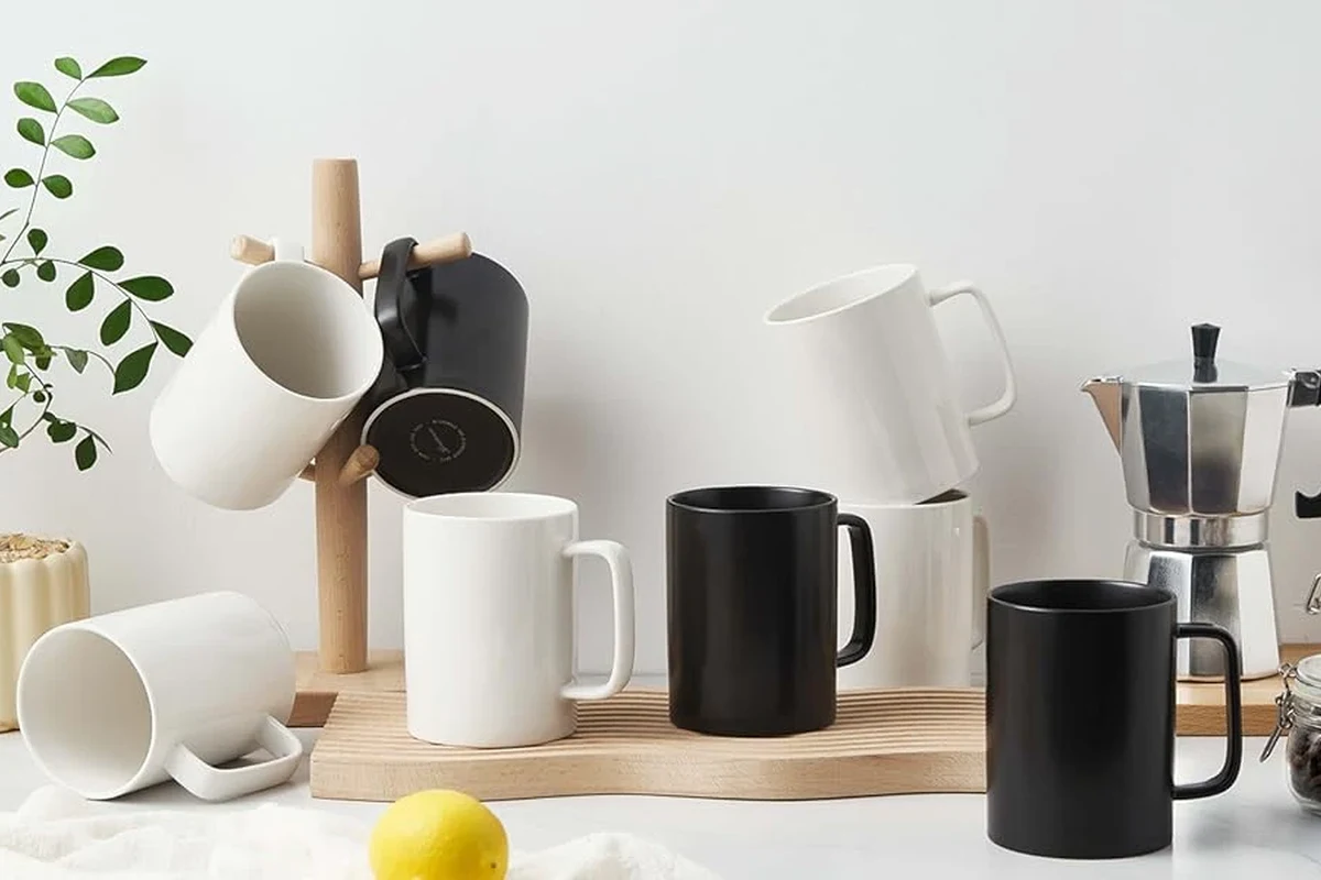 Porcelain coffee mug holding hot coffee on a kitchen counter